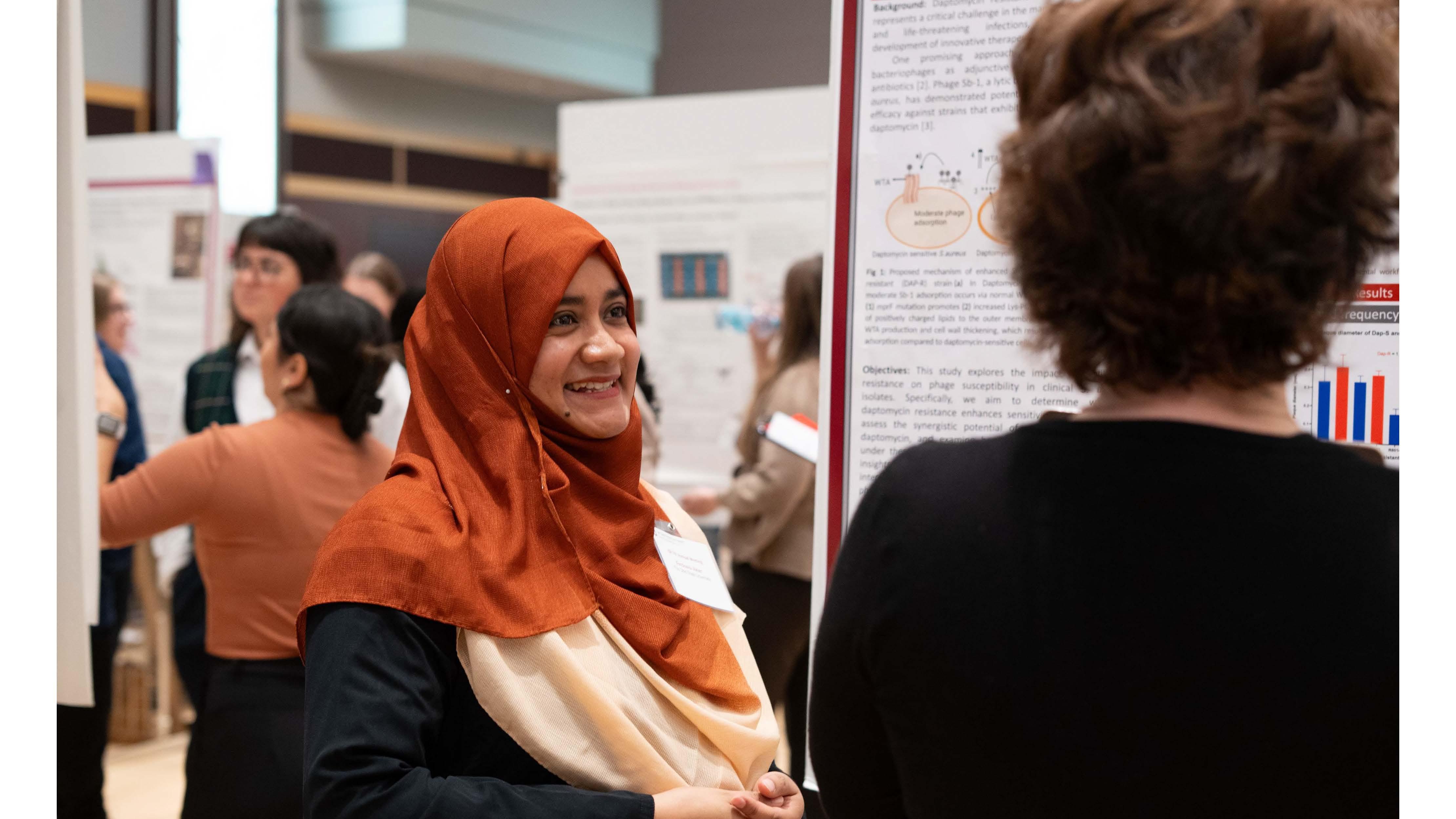 Researchers discussing scientific posters during a poster session.